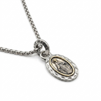 Catholic medal necklace styled with a collared shirt
