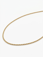Gold rope chain necklace laid flat showing the twisted links