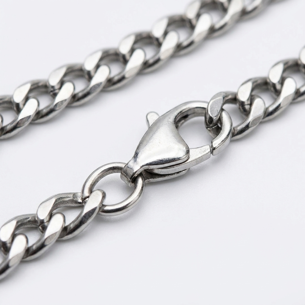 Close-up of the lobster clasp on the silver Cuban link chain