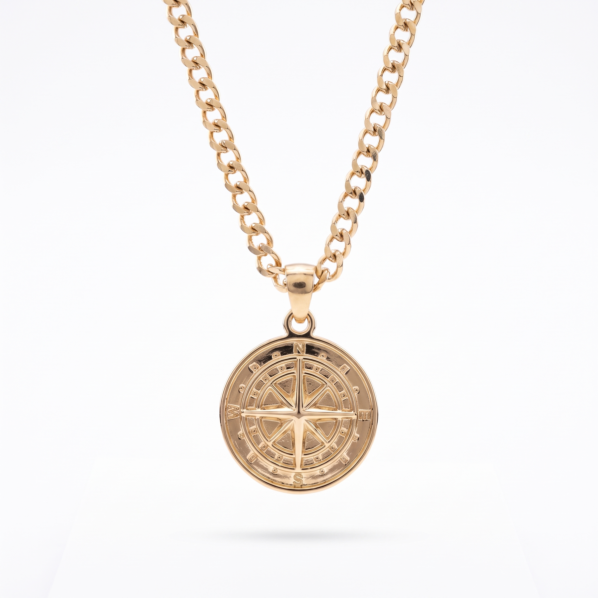 Gold compass pendant necklace on a curb-link chain