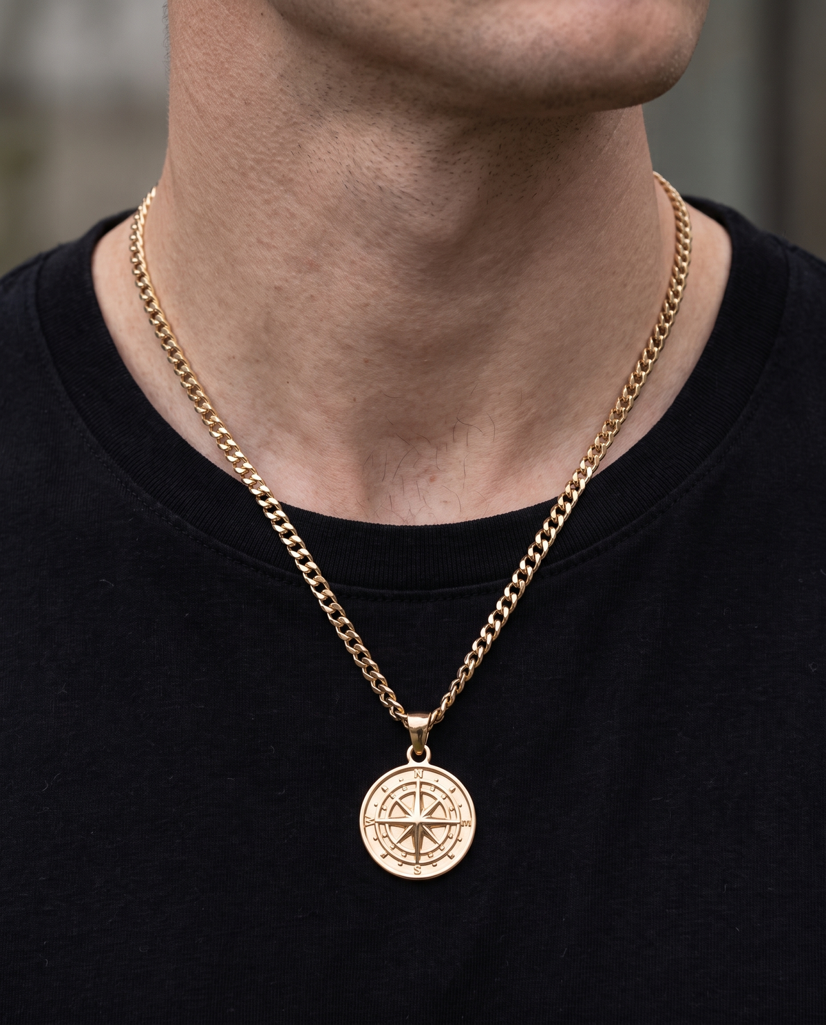 Man wearing the gold compass pendant necklace