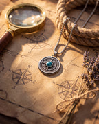 Turquoise compass pendant necklace laid flat, showing the rolo-link chain